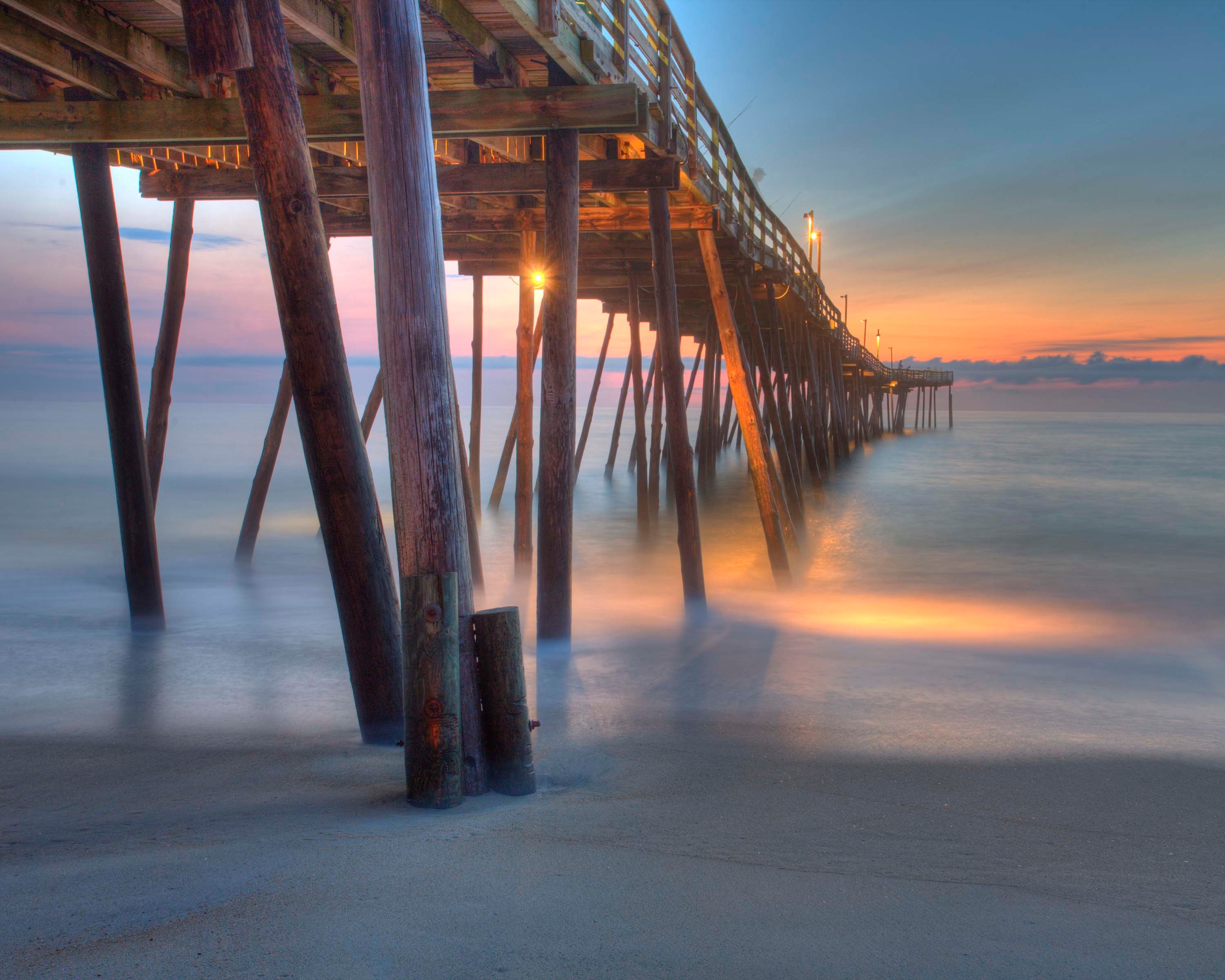 Free photo An old wooden pier at sunset.