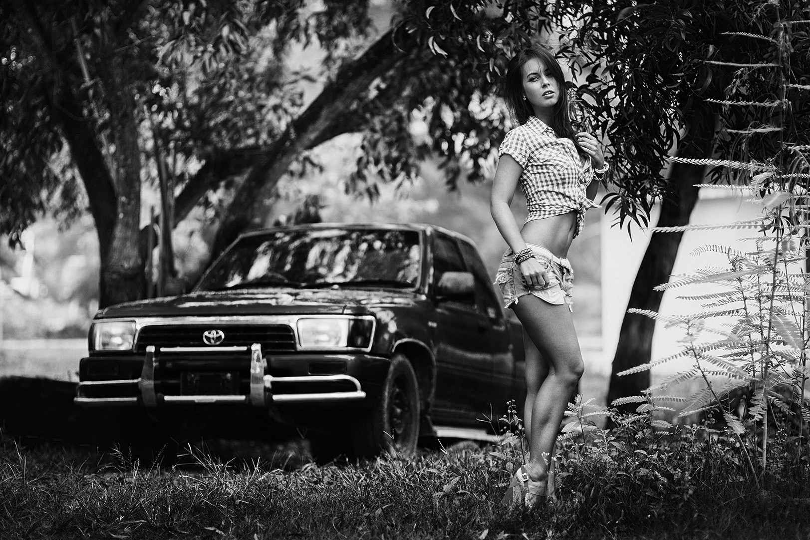 A girl posing on a black car