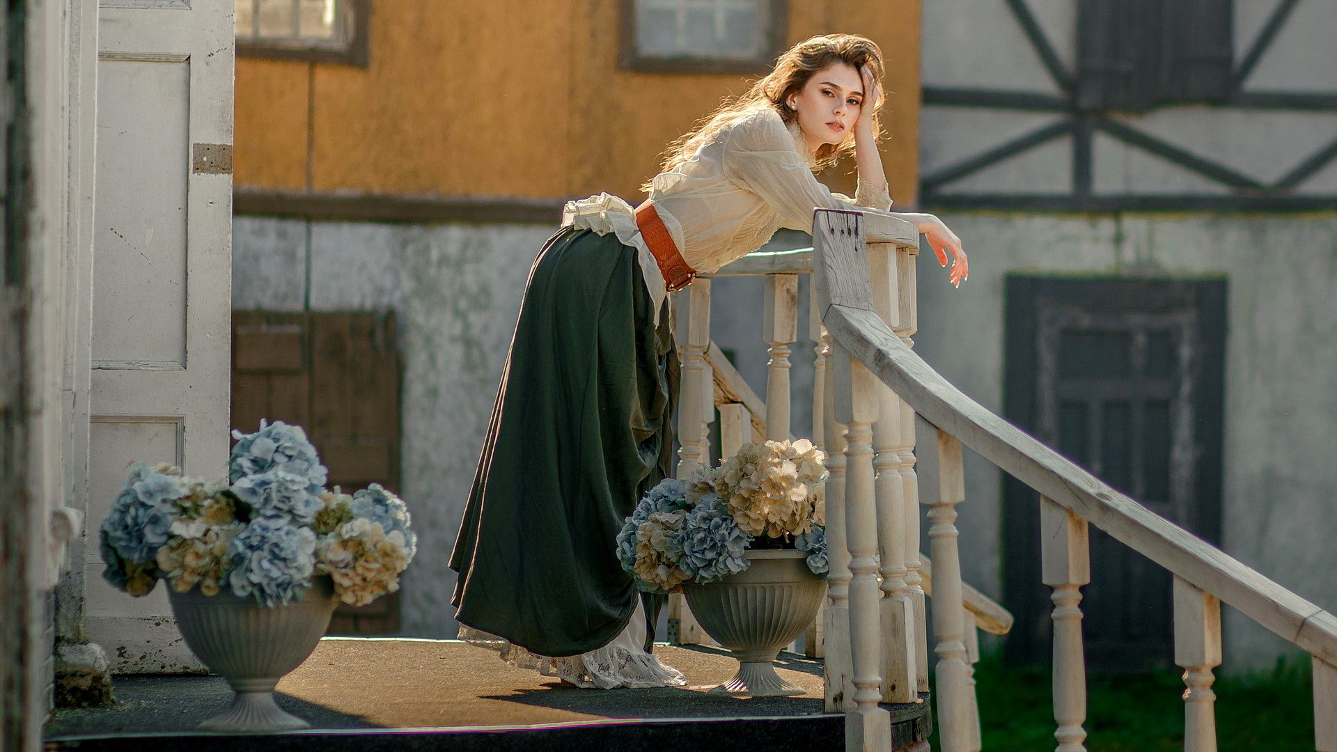 Free photo Model Anastasia Orlovskaya standing on the porch