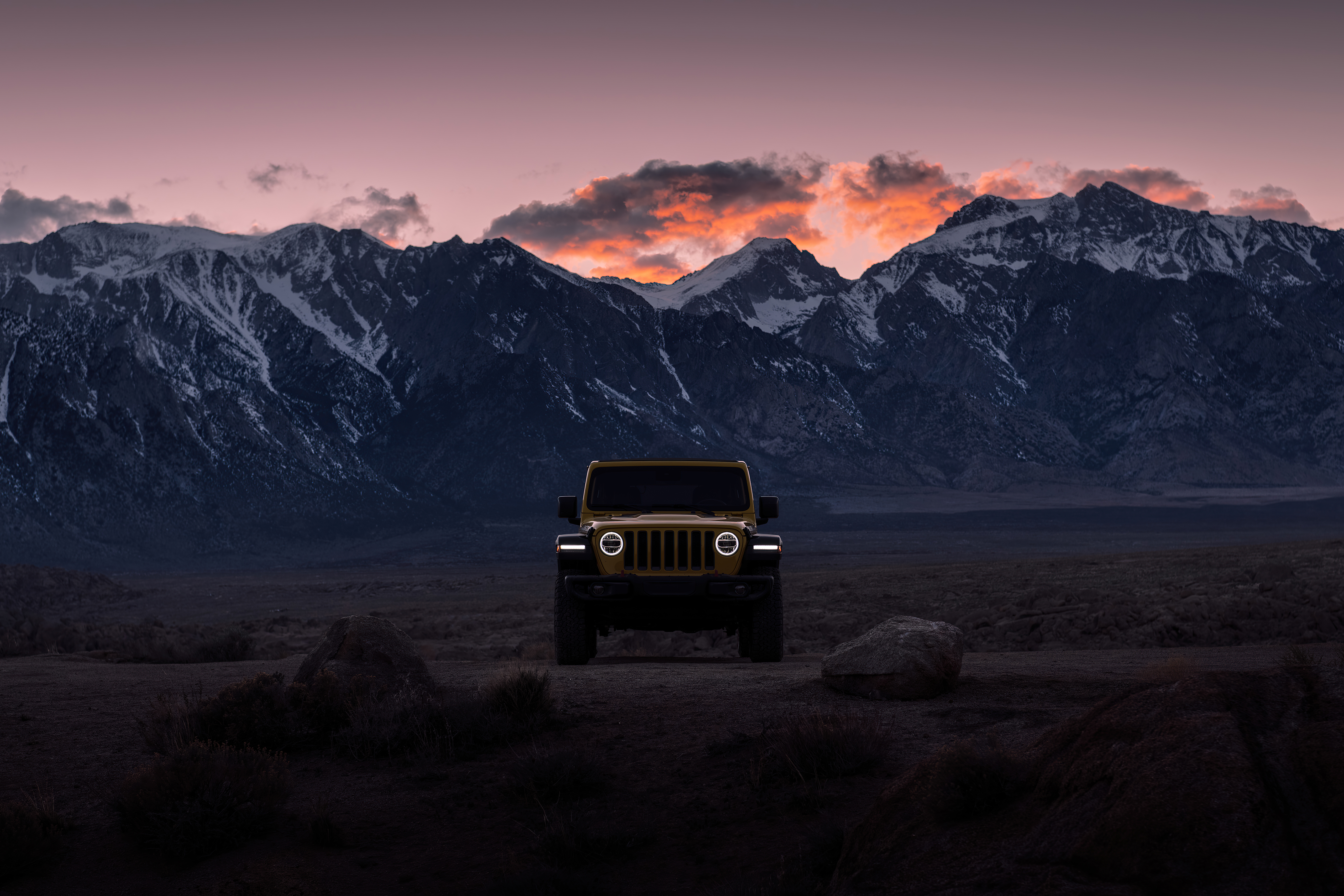 Jeep Wrangler in the evening in front of the big mountains