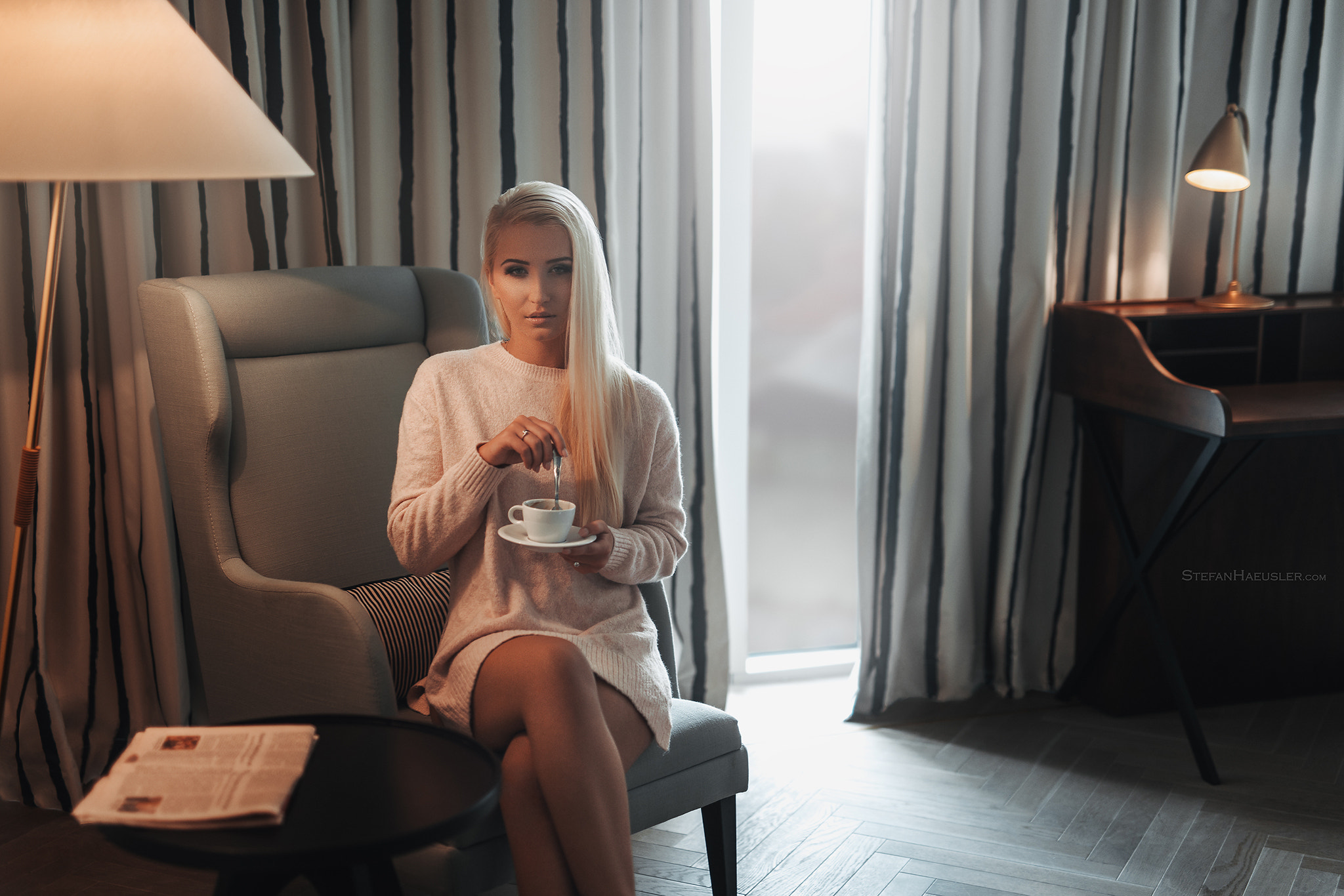 A white-haired girl with a cup of coffee.