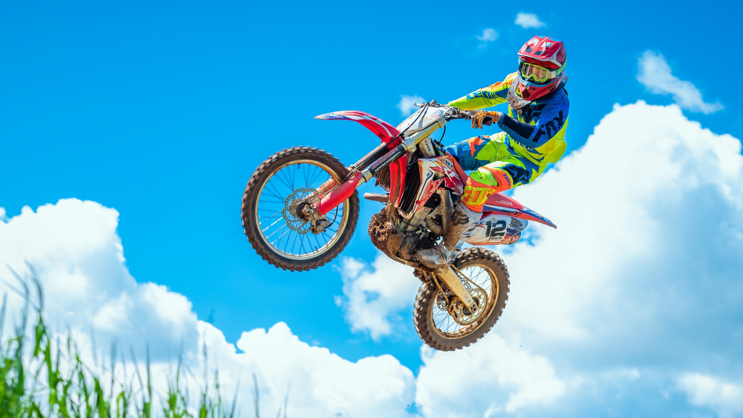 A motorcyclist in a jump against the sky.